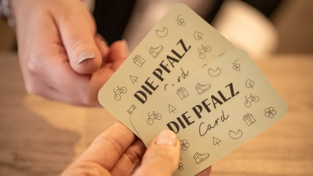 Zwei Pfalzcards werden an der Rezeption überreicht